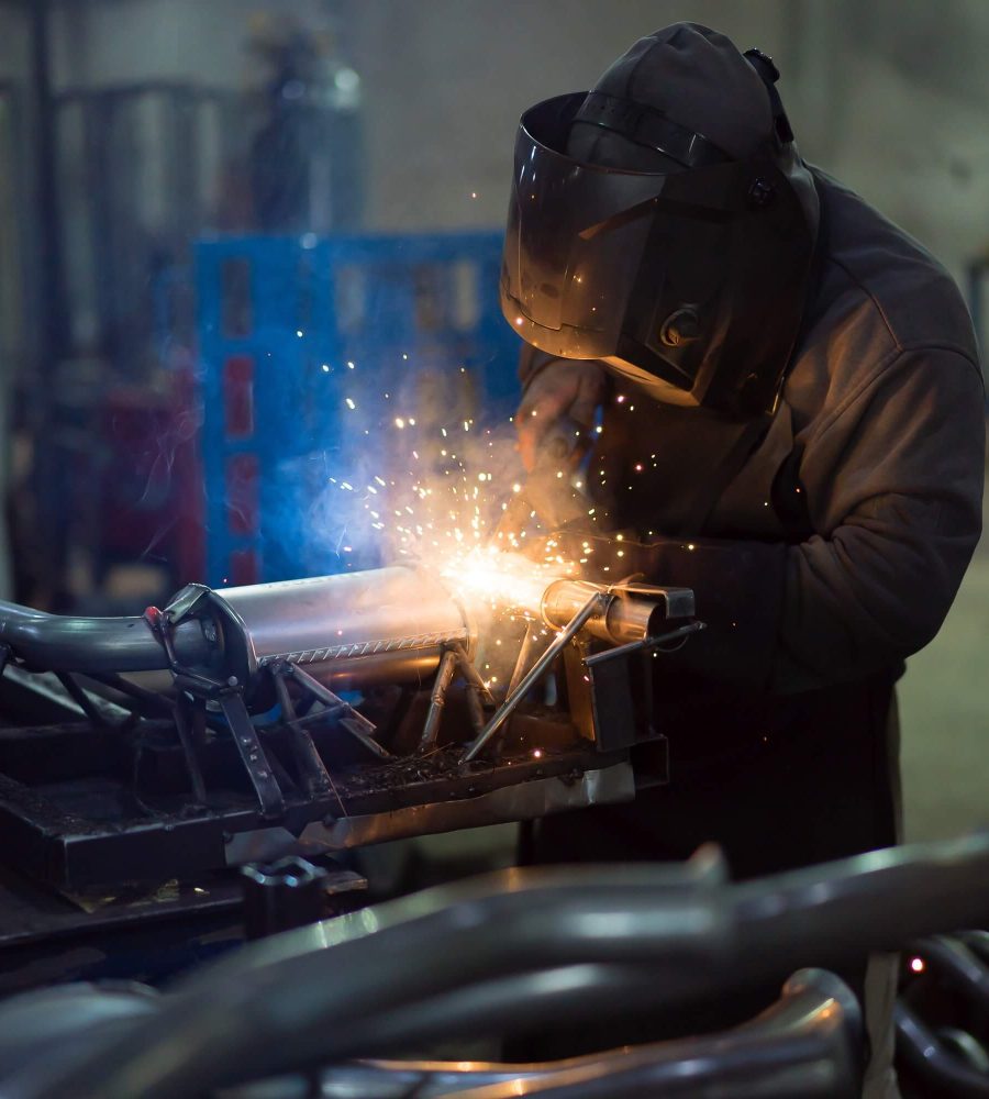 worker-welding-exhaust-pipes-pieces-together-1.jpg worker-welding-exhaust-pipes-pieces-together-1.jpg